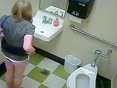 A sexy girl is peeing in the college toilet