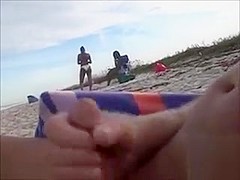 Horny daddy pisses and jerks off his penis on a black babe at the beach