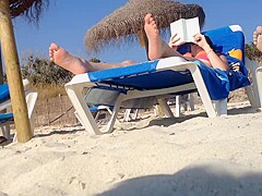 Brunette's candid feet at the beach