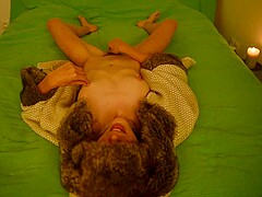 Young amateur teen masturbating and moaning on the bed wearing fur coat